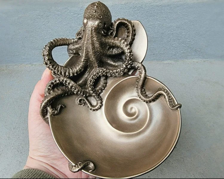 Brass and copper nautilus seashell with octopus tentacles on Craiyon